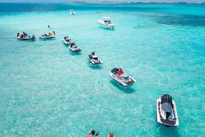 Line of jet skis on brilliant turquoise water aerial view
